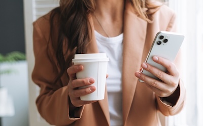 Professional woman with coffee and phone