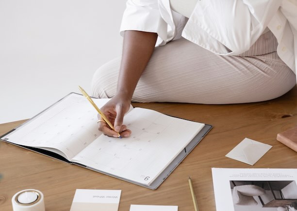 Woman writing in a planner
